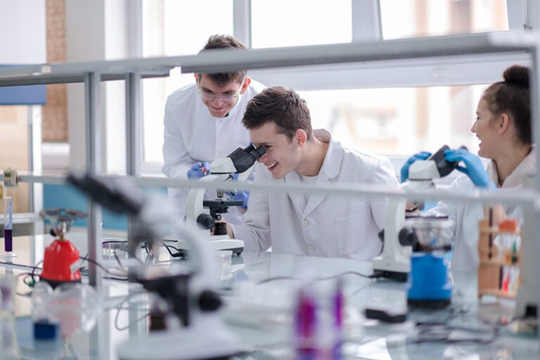 Group of young medical students doing research together in chemistry laboratory,teamwork by college student indoors