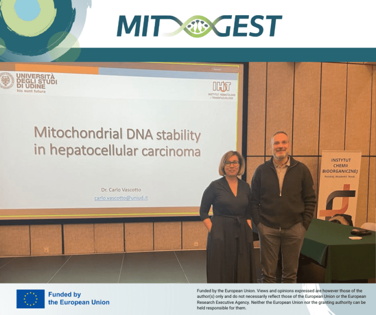 Two people standing in front of the screen with the presentation title Mitochondrial DNA stability in hepatocellular carcinoma